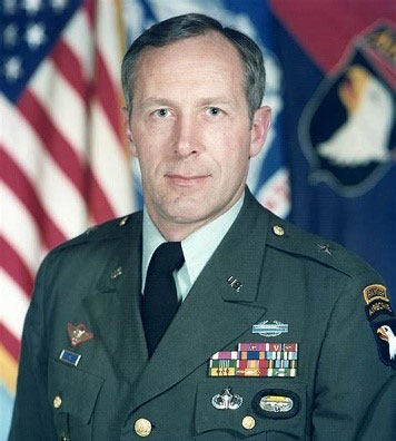 Pete Dawkins in uniform with flag in background.