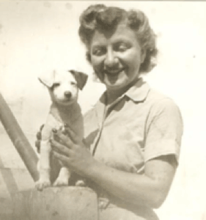 Aleda Lutz smiling with puppy